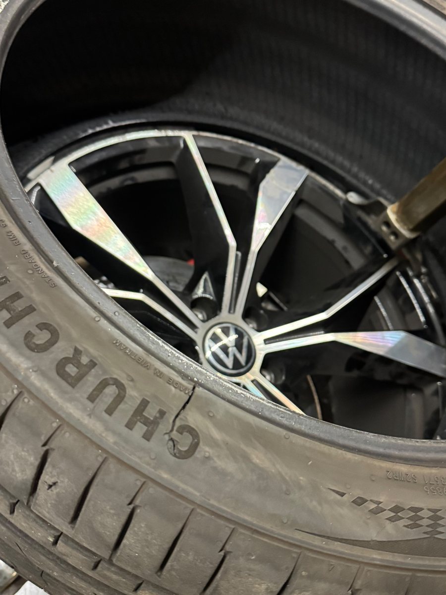 Damaged tyre with a split sidewall, before roadside replacement